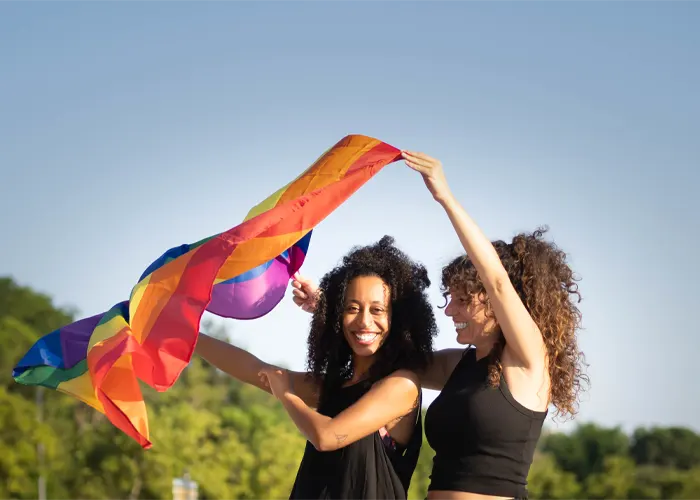 multiethnic-friends-with-the-lgbt-flag-in-the-street
