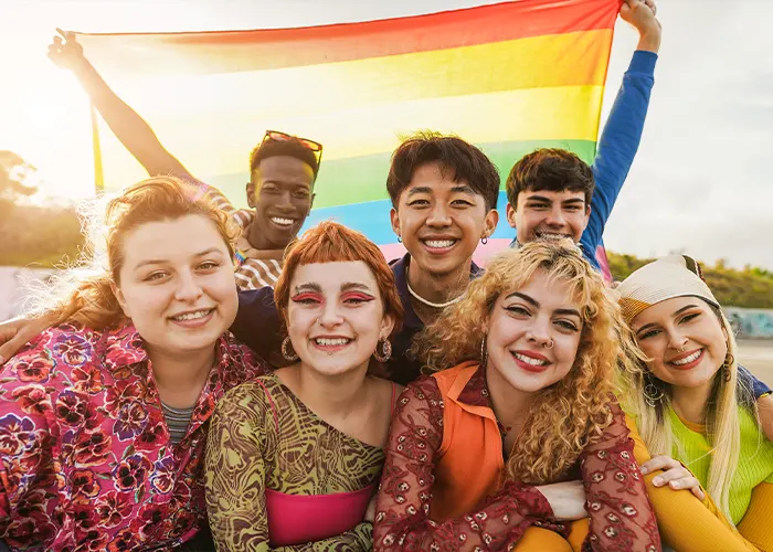Young Diverse People Having Fun Holding LGBT Rainbow Flag Outdoor