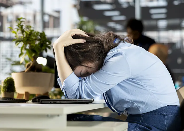 Young employee experiencing emotional strain and frustration