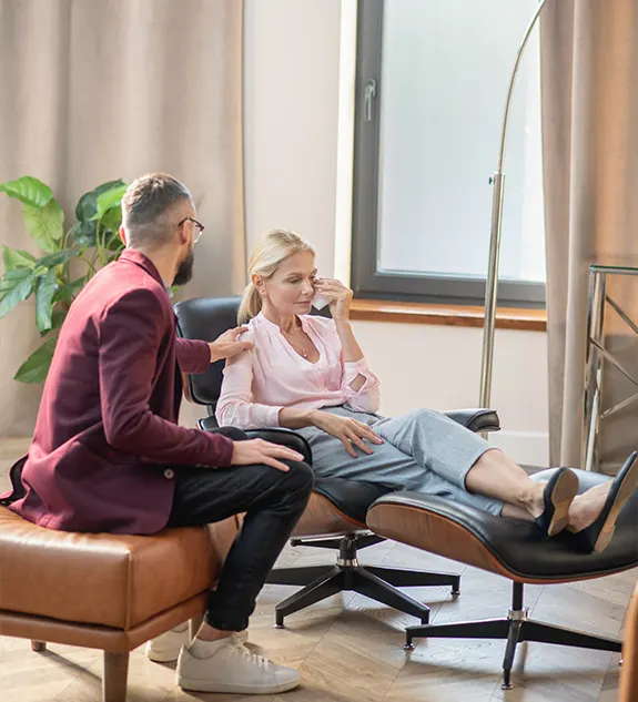 Young psychologist providing support to a crying woman