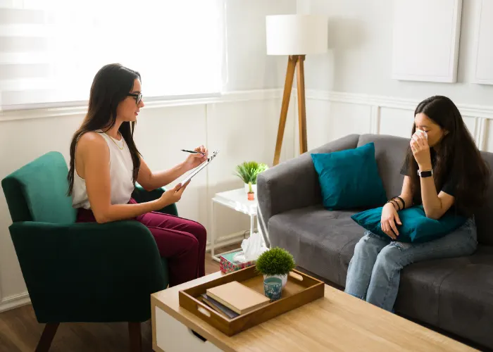 Girl Wiping Her Tears In Therapy Session