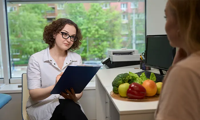 Woman Nutritionist Advises a Client in a Fitness